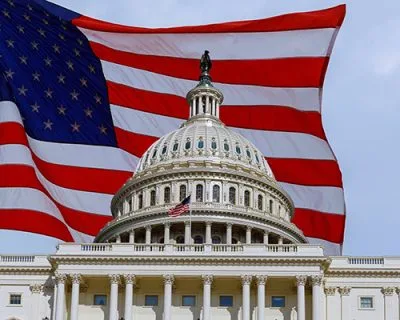 Washington DC Capitol Building on Capitol Hill detail on american flag background USA