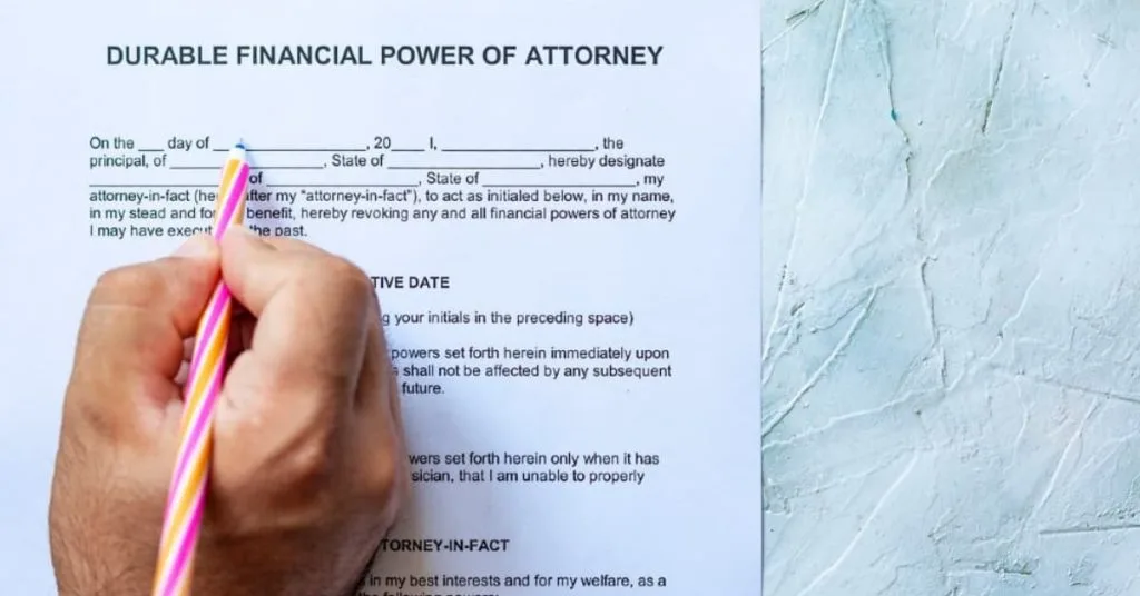 Person filling out a durable financial power of attorney form.