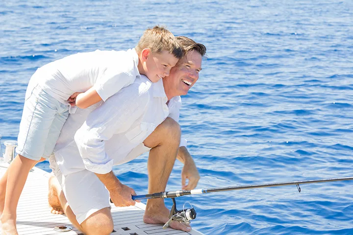 guy on boat with a kid
