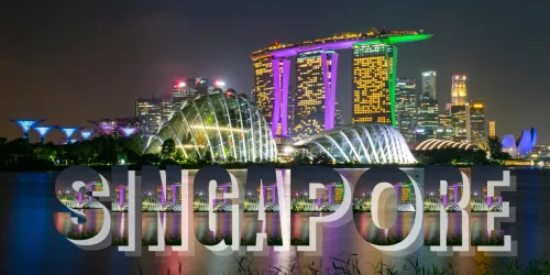 Night view of Singapore's skyline with illuminated landmarks and "Singapore" text overlay.