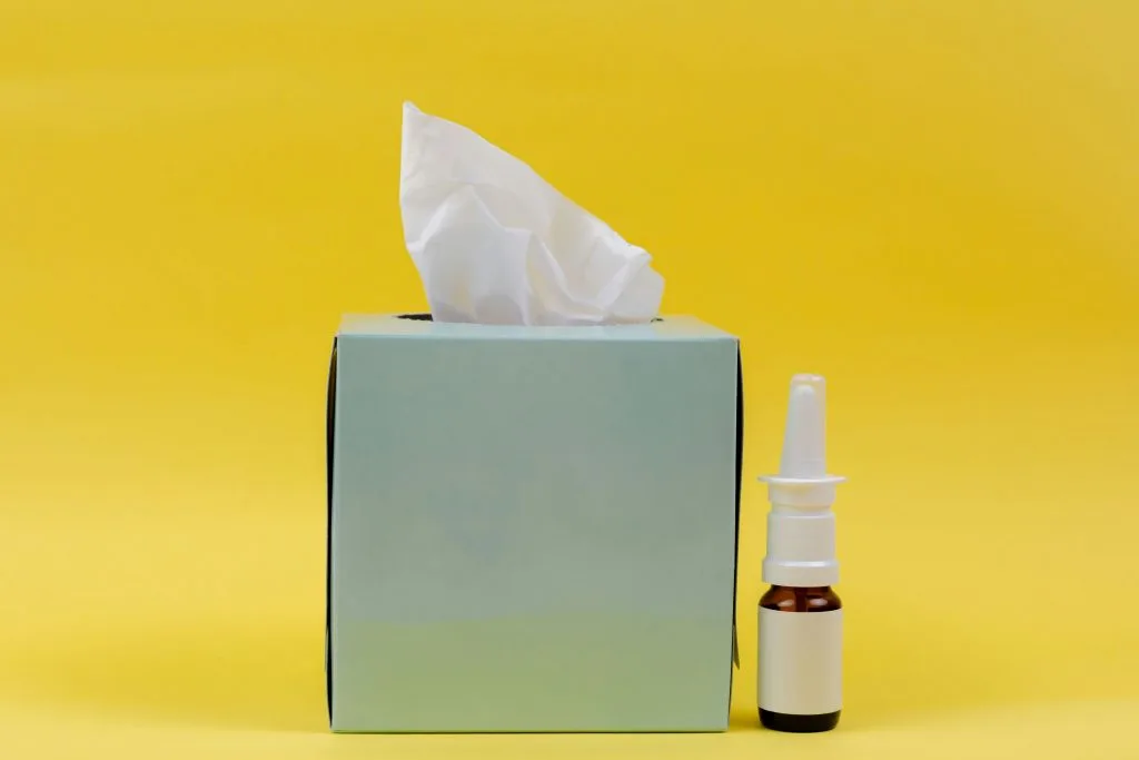 Nasal spray next to tissues