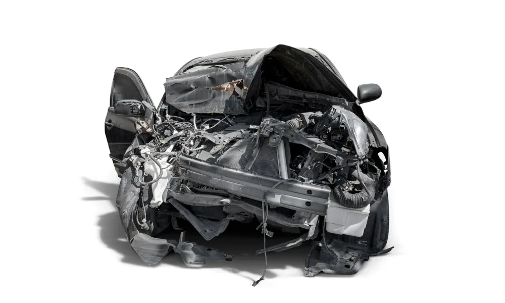 Front view of a very badly damaged car, signifying what happens when your car is totaled.