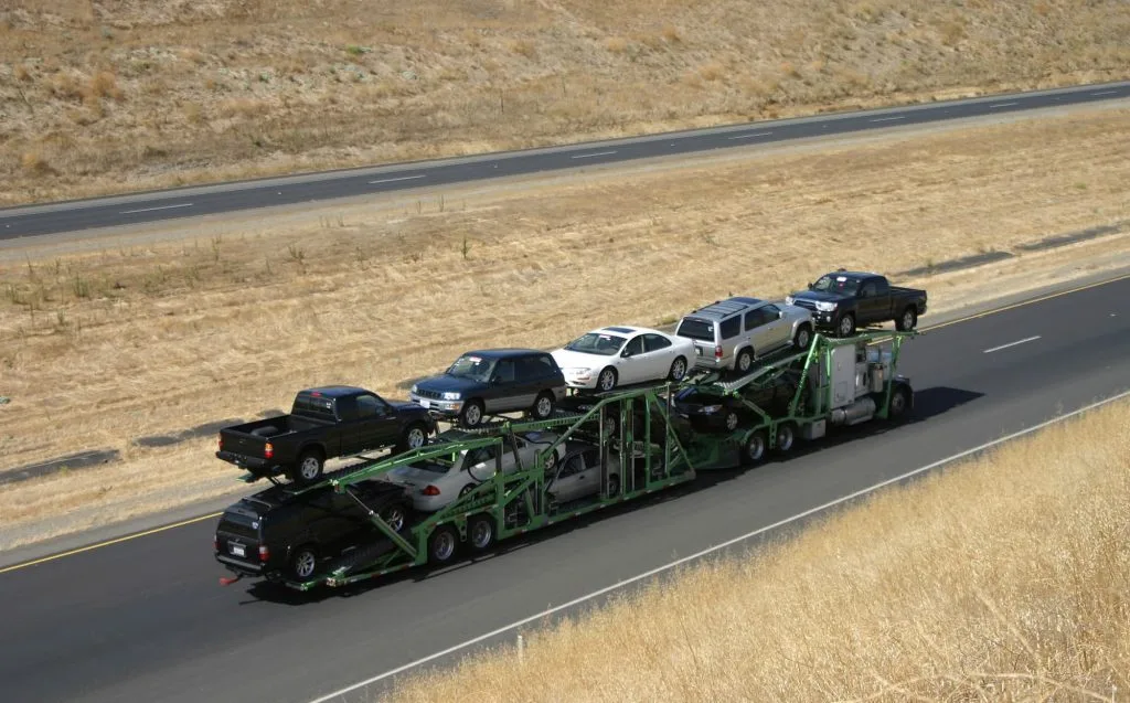 large truck hauling cars on highway