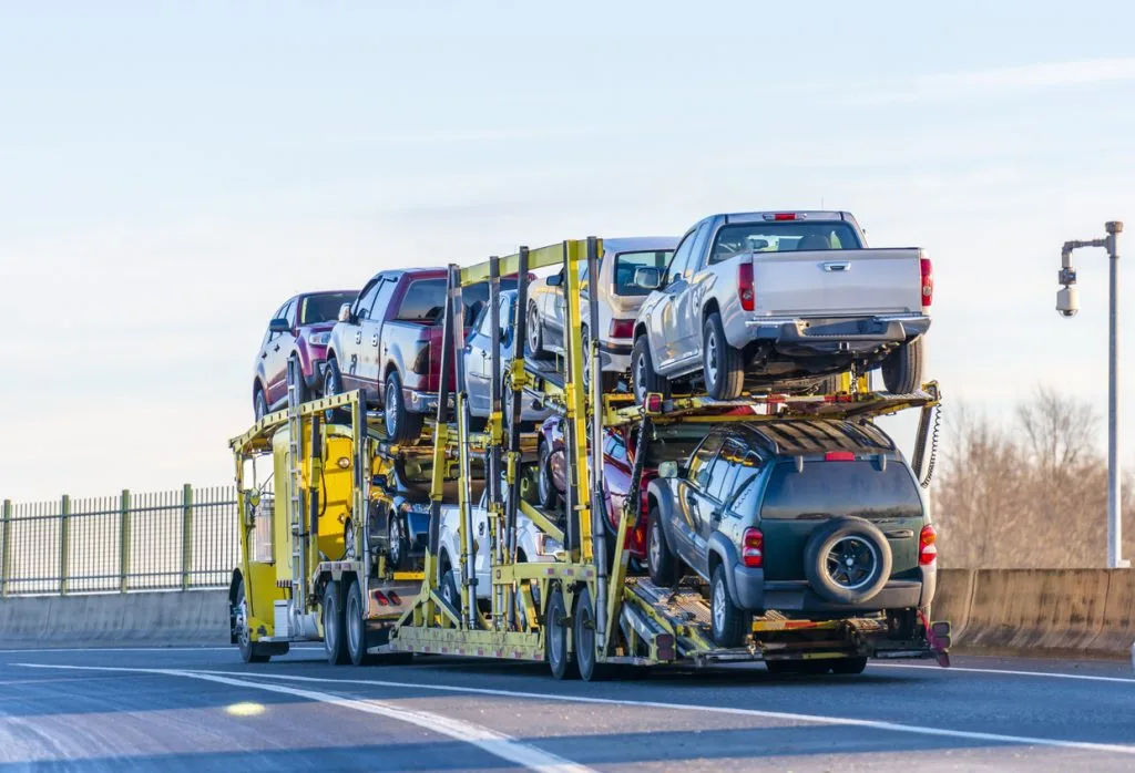 yellow-big-rig-car-hauler-with-several-cars-loaded