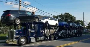 Professional tow truck preparing to transport a car for a 100-mile journey