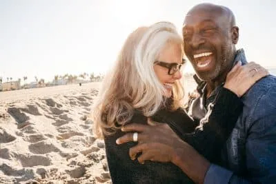 retired couple vacationing on a beach, snowbird and vacation concept