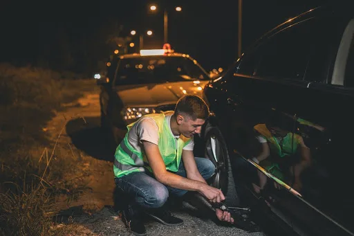 roadside assistance helping fix a tire