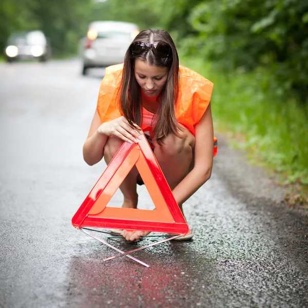woman on a road. broken car.