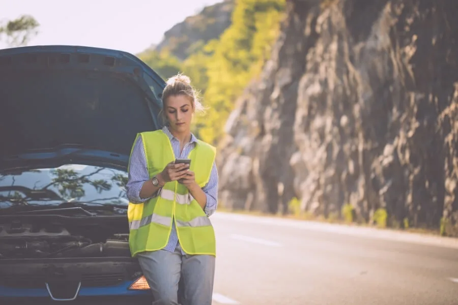 woman texting family about stuck car
