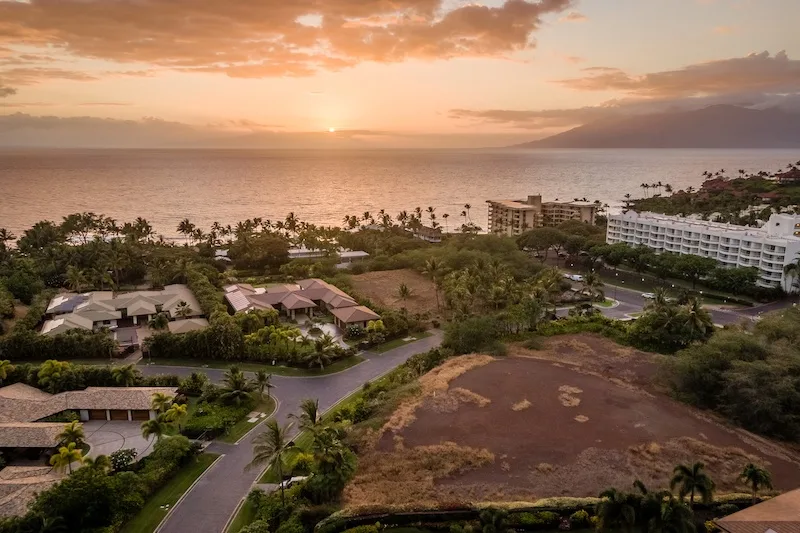 Maui Real Estate Market Update Q2 2023 Vol. 2 1 A drone shot shows the sun starting to set. Our vacant land listing in Palauea is in the foreground.