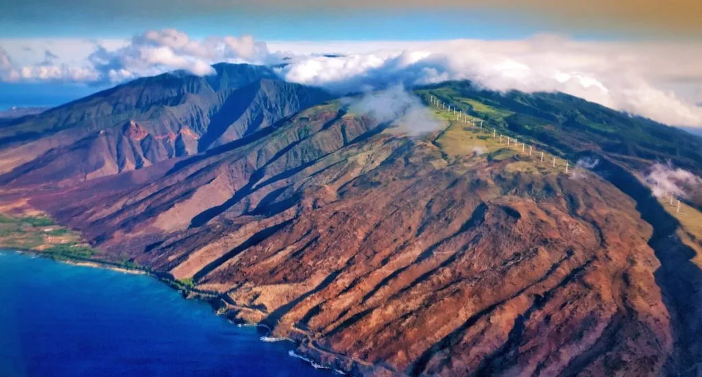 Maui Real Estate Market Update Q3 2024 Vol. 3 Cover Image Aerial View of the West Maui Mountains