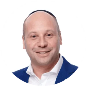 Portrait of a bald man wearing a kippah and a blue blazer, smiling, representing Nussbaum family lawyers in Toronto