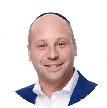 Portrait of a bald man wearing a kippah and a blue blazer, smiling, representing Nussbaum family lawyers in Toronto