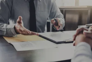 hands gesturing over papers on a desk