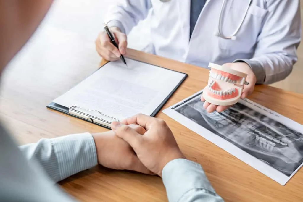 austin periodontist reviewing x-rays and explaining periodontal treatment plan to a patient