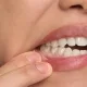 signs of gum disease: early warning symptoms you shouldn't ignore 5 person pulling down their lower lip to show teeth and gums.