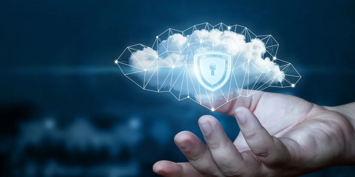 Person's hand holding a digital cloud with a padlock symbol, representing cybersecurity and data protection concept.