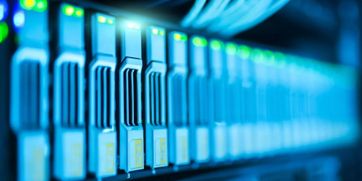 Close-up of high-tech data server with illuminated connection ports and cables, showcasing modern computing technology.