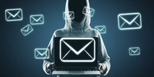 Person in a hoodie holding a laptop displaying an email icon, surrounded by floating email graphics.