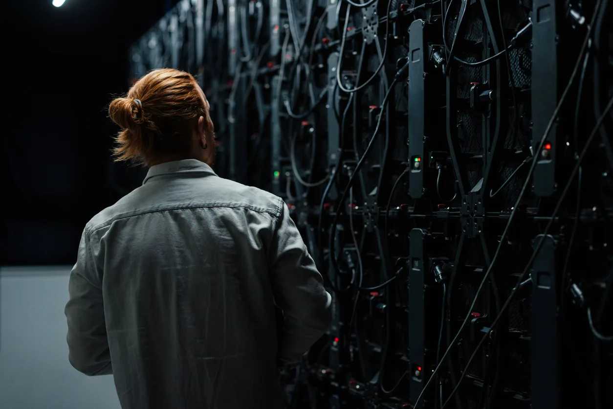 Technician examining a server room.