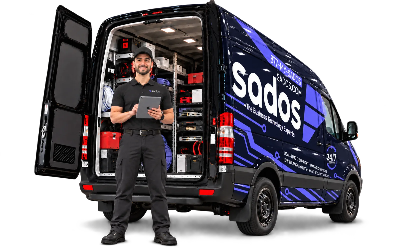 SADOS technician holding an iPad during an on-site IT survey at a SADOS-wrapped service van.
