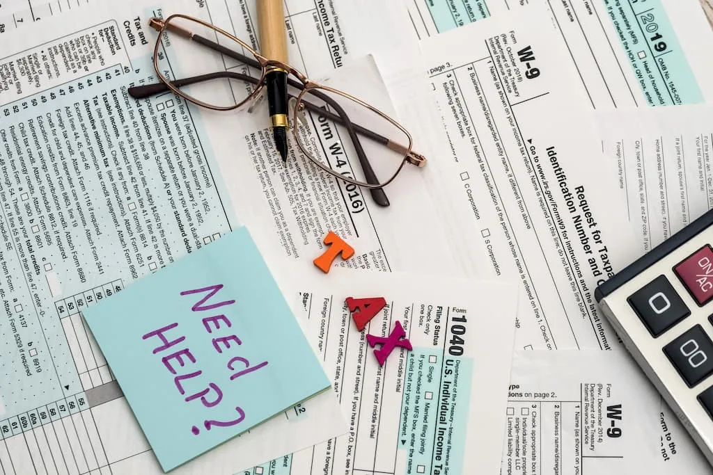 A cluttered desk with tax forms