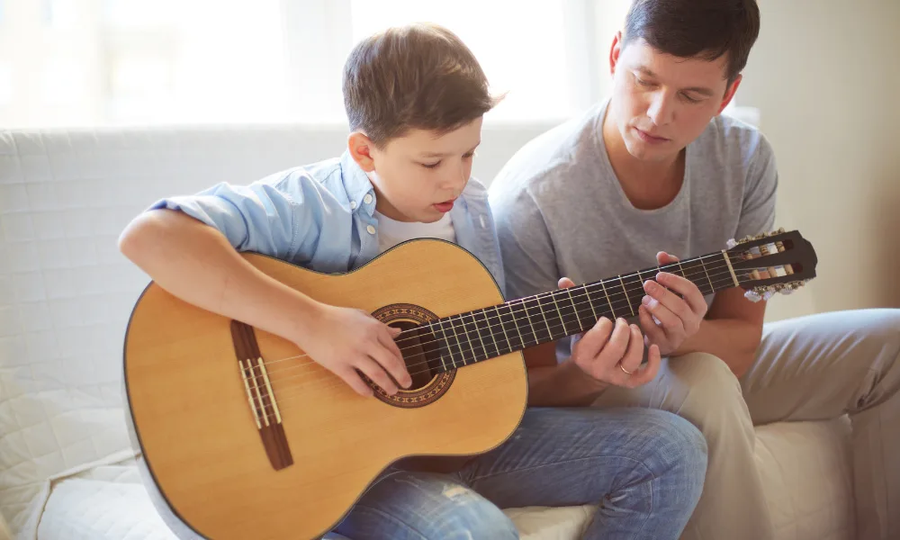 child learning the guitar for the first time