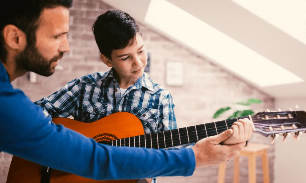 Guide to Learn the Differences Between Guitars: Acoustic, Classical or Electric. Which One Fits You? 3 boy taking classical guitar lessons