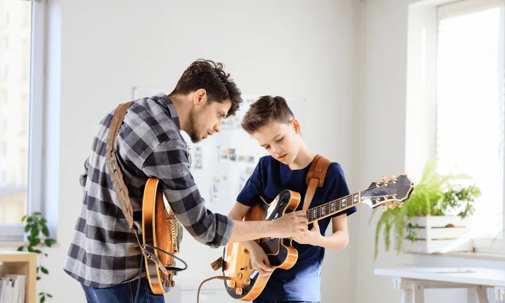 Guide to Learn the Differences Between Guitars: Acoustic, Classical or Electric. Which One Fits You? 5 boy taking electric guitar lessons