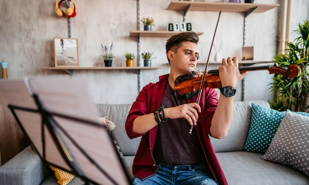 Practice Smarter, Not Longer: 9 Tips to Getting the Most Out of Your Practice Time 9 Young male violinist practicing music at home.