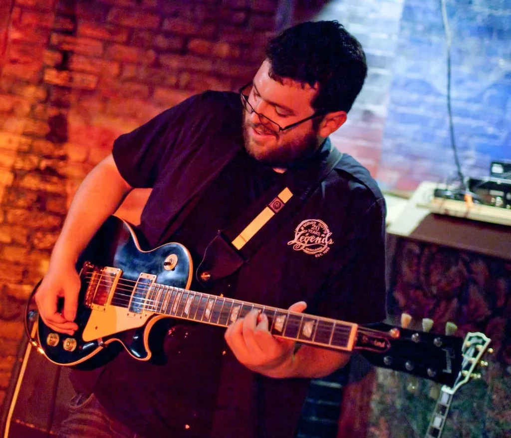 Anthony Sloan the music instructor playing guitar
