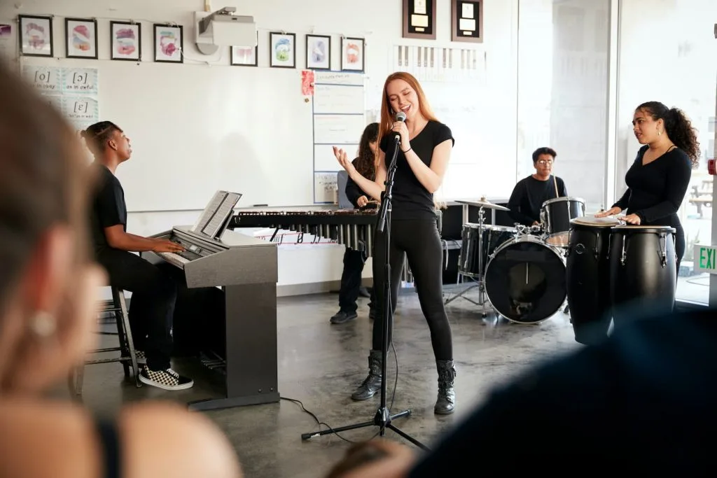 group of artists playing various instruments with main singer