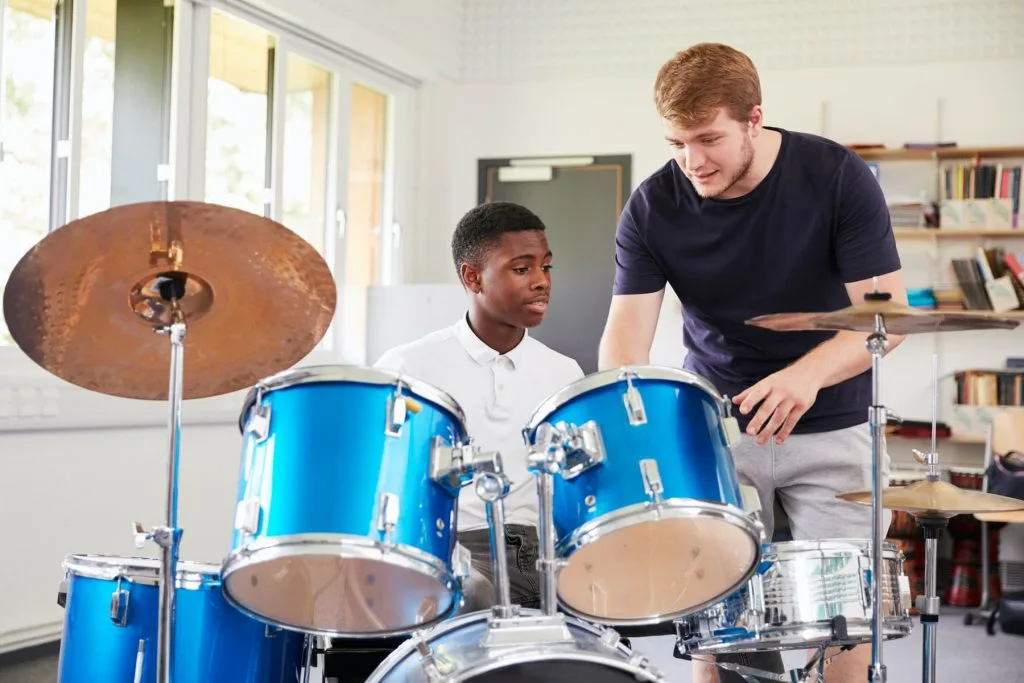 drum instructor teaching student how to play drums