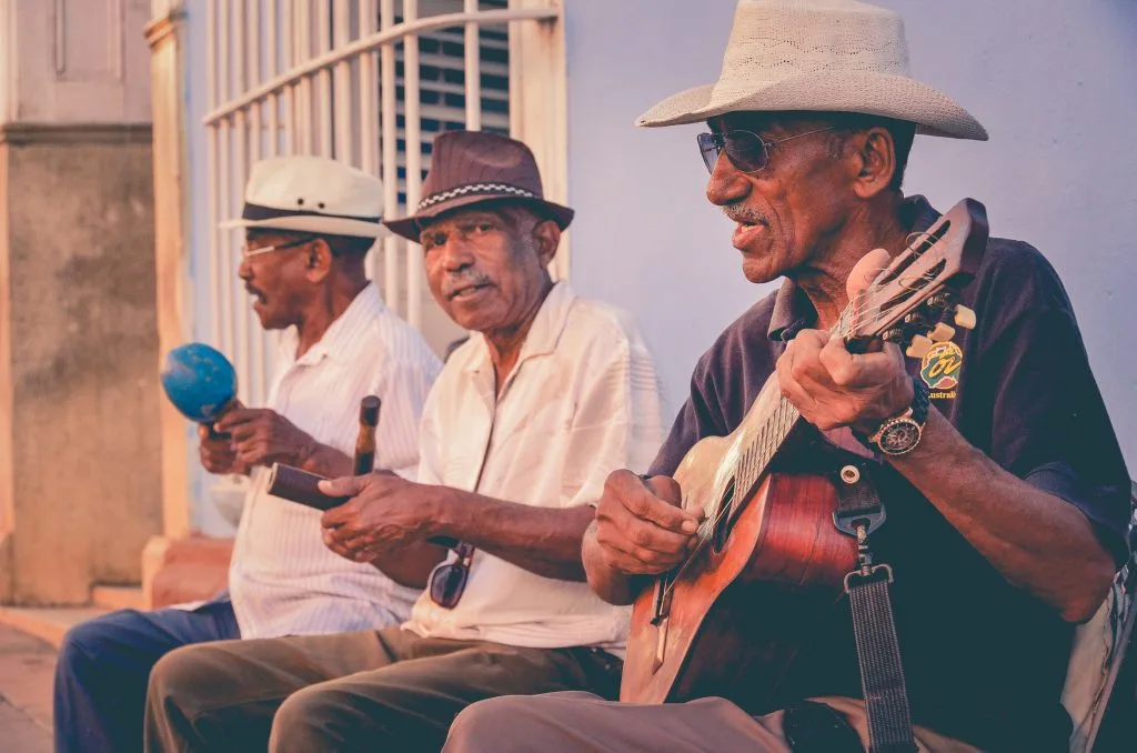 7 Ways Learning Music Boosts Brain Power in Older Adults 16 three adults learning music outside