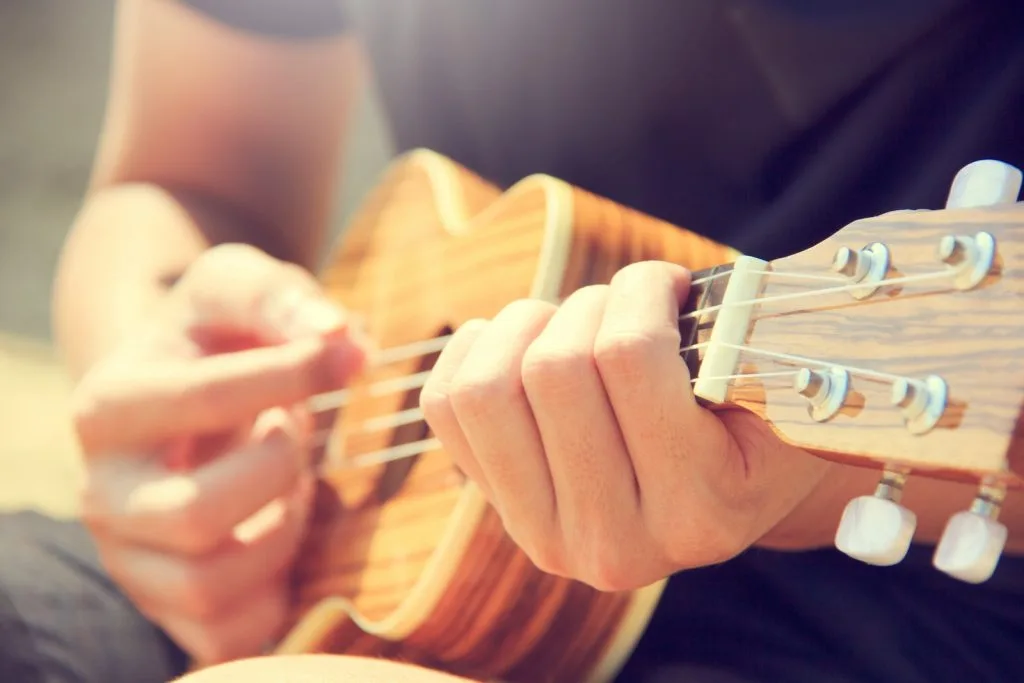 man learning ukulele in virtual music lesson