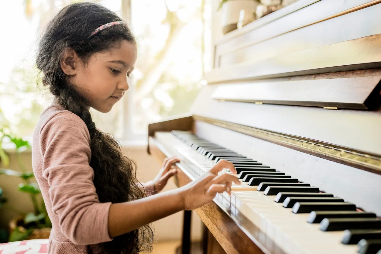 little girl learning piano for the first time