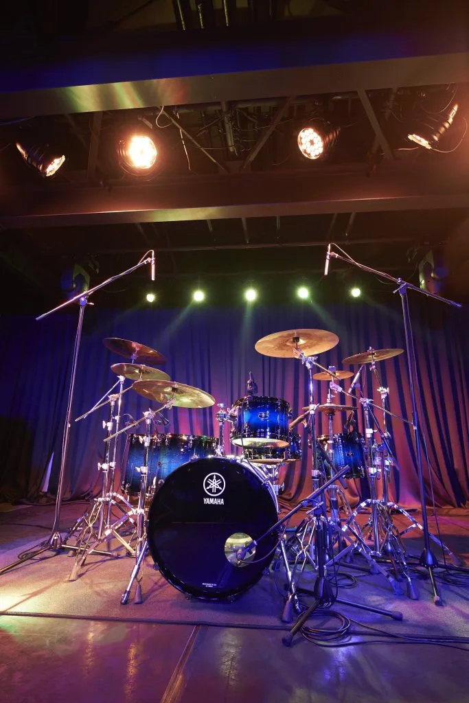 Drum set under stage lights.