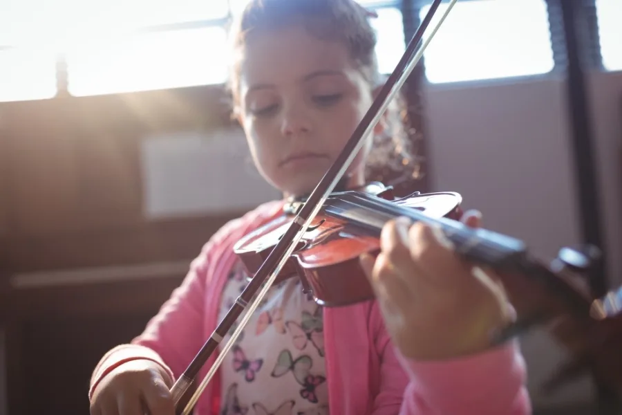 A Musical Instrument Rental Comprehensive Guide 2 Girl student rehearsing violin