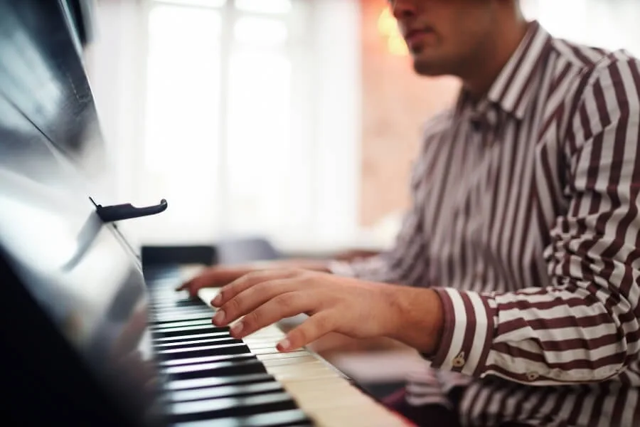 6 Impressive Benefits of Playing Piano 1 Man is playing piano