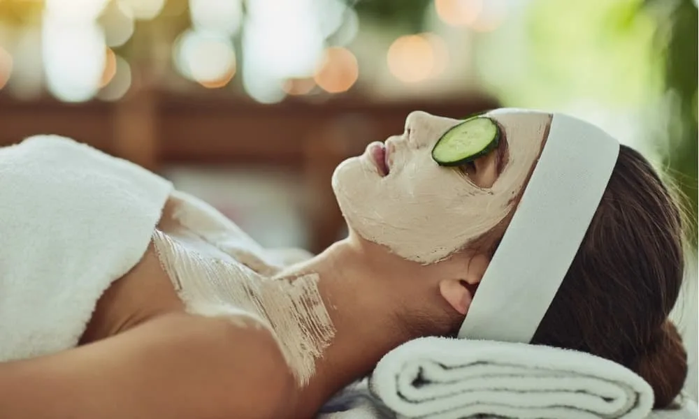 a woman receiving a face mask and cucumber treatment at a rehoboth beach spa
